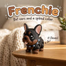 Black and Tan Frenchie French Bulldog 3D printed articulated flexi toy by Cosmic 3D Creations, on a cozy side table with a knit blanket
