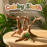 Cubby Sloth 3D printed articulated flexi toy by Cosmic 3D Creations, on a sunlit table with tropical leaves