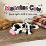 Manatee Cow 3D printed articulated flexi toy in black and white cow print by Cosmic 3D Creations, on a farmhouse shelf with wheat