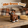 Mini Brown Pony 3D printed articulated flexi toy by Cosmic 3D Creations, on a farmhouse shelf with wheat