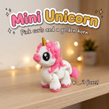 Mini Unicorn 3D printed articulated flexi toy by Cosmic 3D Creations, on a cozy shelf with fairy lights
