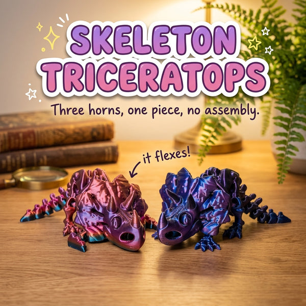 Skeleton Triceratops 3D printed articulated flexi toy by Cosmic 3D Creations, on a wooden desk with books and a fern