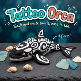 Tattoo Orca 3D printed articulated flexi toy by Cosmic 3D Creations, on slate with shells and sea glass