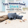 Tiny Hammerhead Shark 3D printed articulated flexi toy by Cosmic 3D Creations, on sand with driftwood and shells