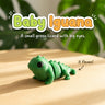 Baby Iguana 3D printed articulated flexi toy, on a sunlit table with tropical leaves