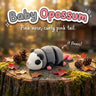 Baby Opossum 3D printed articulated flexi toy, on a tree stump with moss and pine cones