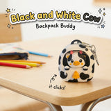 Black and White Cow Backpack Buddy 3D printed clicker fidget keychain on a school desk