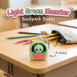 Light Green Monster Backpack Buddy 3D printed clicker fidget keychain on a school desk