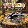 Big Skunk 3D printed articulated flexi toy by Cosmic 3D Creations, on a tree stump with moss and pine cones