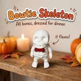 Bowtie Skeleton 3D printed articulated flexi toy by Cosmic 3D Creations, on a cozy autumn shelf with pumpkins