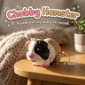 Chubby Hamster 3D printed articulated flexi toy by Cosmic 3D Creations, on a cozy side table with a knit blanket
