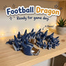 Football Dragon 3D printed articulated flexi toy by Cosmic 3D Creations, on a cozy shelf with fairy lights