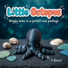 Little Octopus 3D printed articulated flexi toy by Cosmic 3D Creations, on slate with shells and sea glass