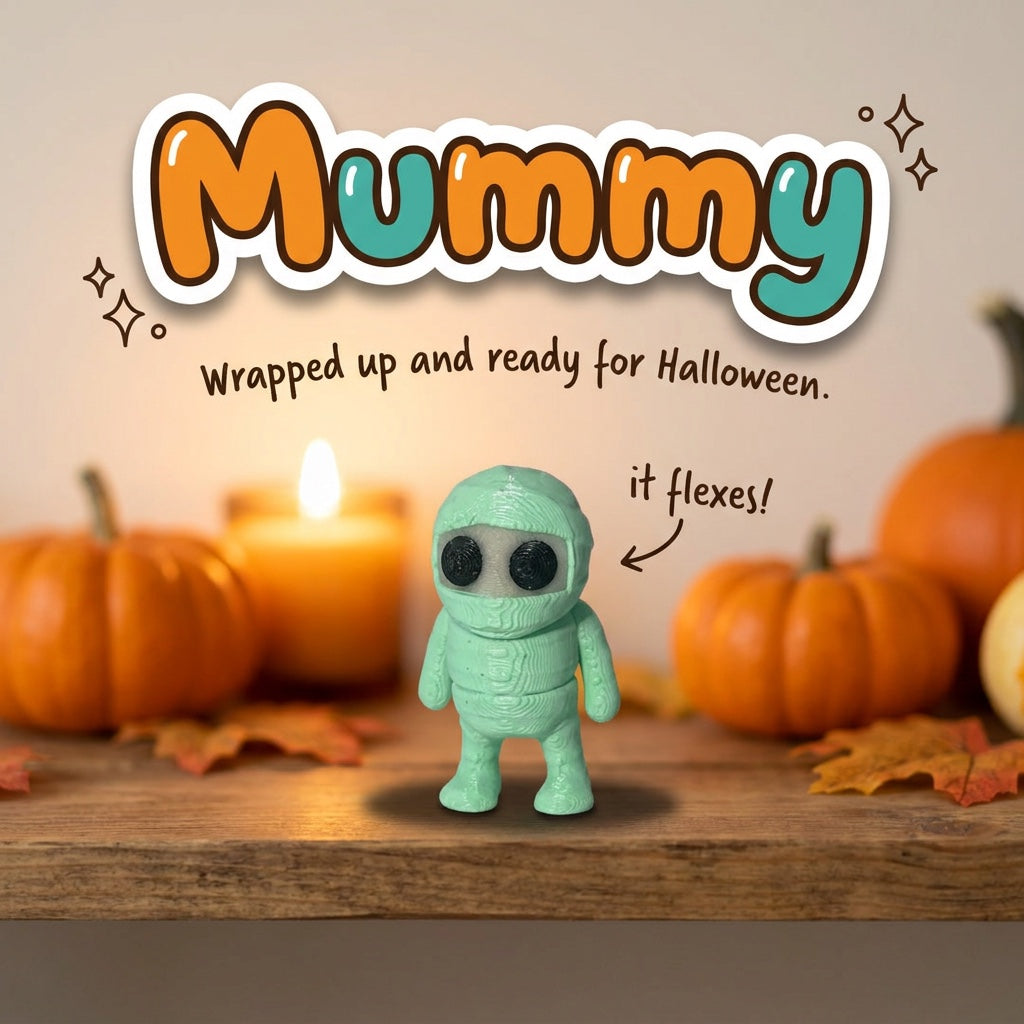 Mummy 3D printed articulated flexi toy, on a cozy autumn shelf with pumpkins