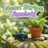 Neon Stripe Axolotl 3D printed articulated flexi toy, on a mossy stone with plants