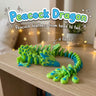 Peacock Dragon 3D printed articulated flexi toy by Cosmic 3D Creations, on a cozy shelf with fairy lights