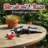 Skunk with Rose 3D printed articulated flexi toy by Cosmic 3D Creations, on a sunny garden table with flowers