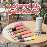 Textured Lip Balm Holder 3D printed keychain caps with clasps by Cosmic 3D Creations, on a cafe table with keys and a tumbler