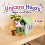 Unicorn House 3D printed articulated flexi toy by Cosmic 3D Creations, on a cozy shelf with fairy lights