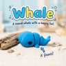 Whale 3D printed articulated flexi toy by Cosmic 3D Creations, on sand with driftwood and shells